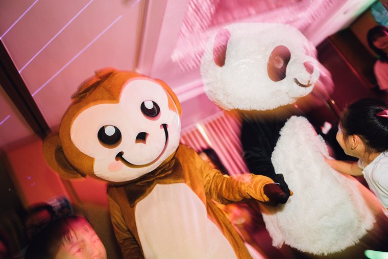 The monkey mascot waving beside the panda mascot at Vol. 2